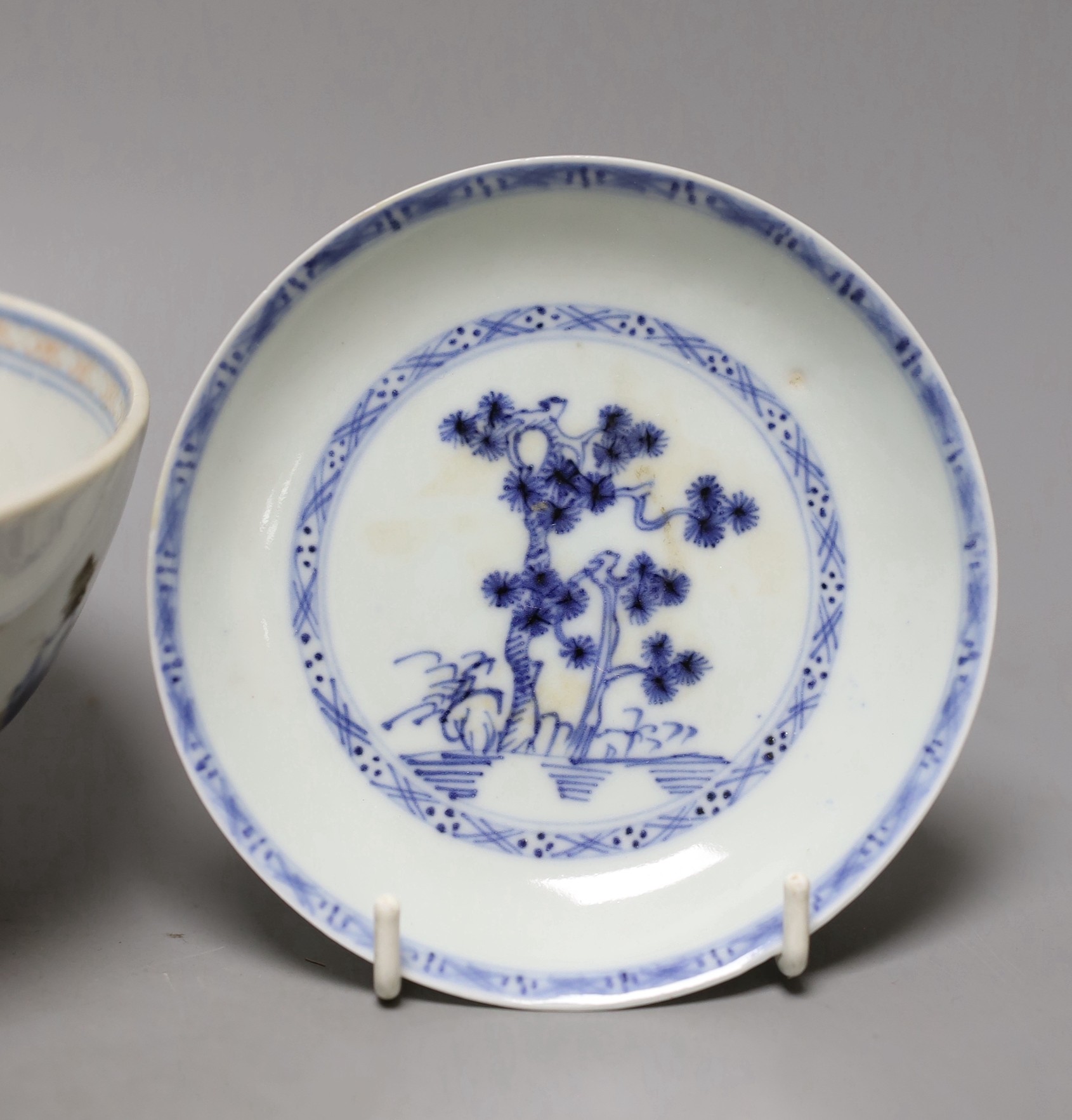 A Chinese Nanking cargo blue and white bowl and a tea bowl and saucer (Christie's label on base)